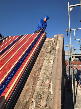 Close up van een hellend dak waar SlimFix RenoTwin isolatieplaten worden gelegd